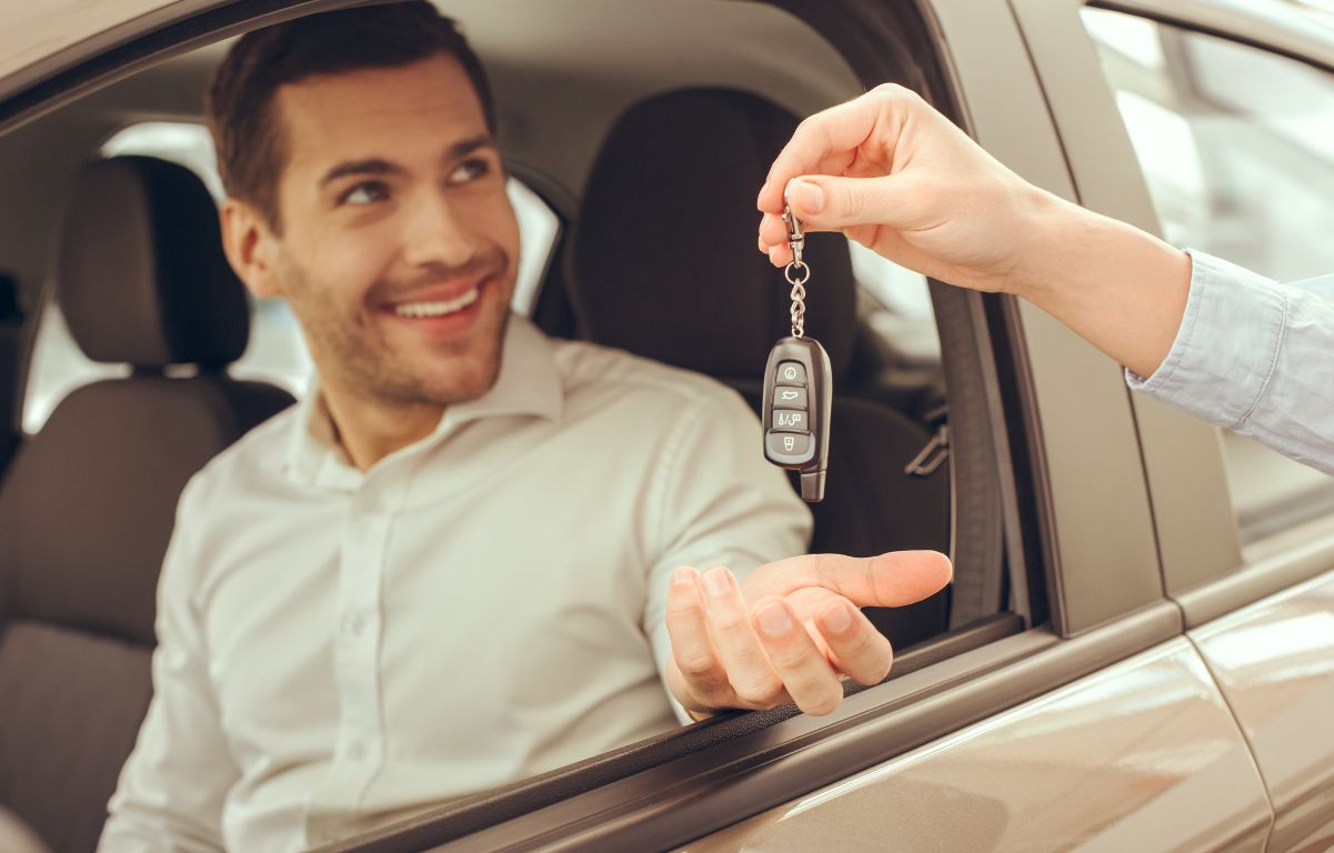 Man handing the keys to the driver