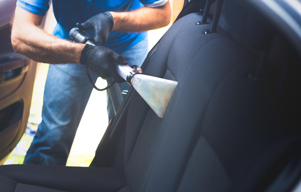 Car upholstery washing by a man