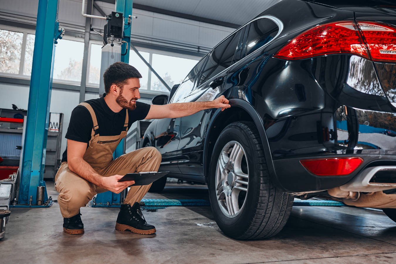 A mechanic looks at a vehicle