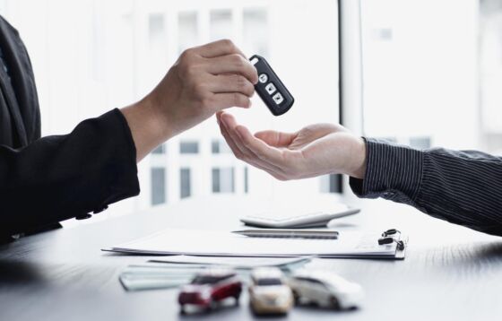Handing over car keys over a car insurance form